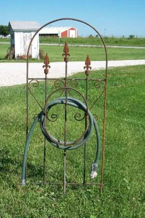 Iron Hose Wheel with 3 Finials & Stakes into the Ground decorative plants  