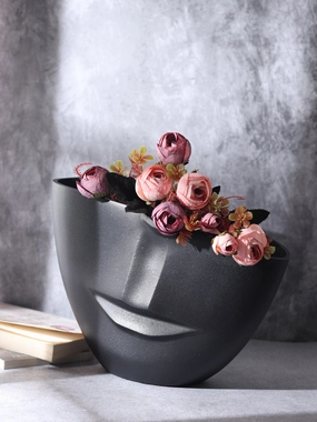 The amused Face Vase in Black outdoor greenery  