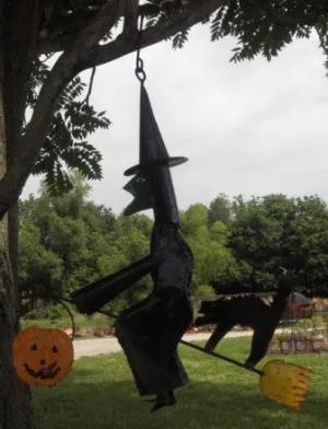Witch on Broom with Cat Hanging dried flower branch  